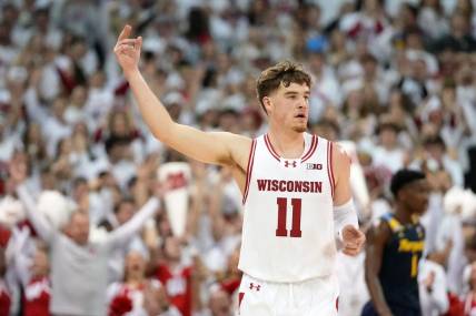 Dec 2, 2023; Madison, Wisconsin, USA;  Wisconsin Badgers guard Max Klesmit (11) celebrates after scoring a three point basket against the Marquette Golden Eagles during the first half at the Kohl Center. Mandatory Credit: Kayla Wolf-USA TODAY Sports