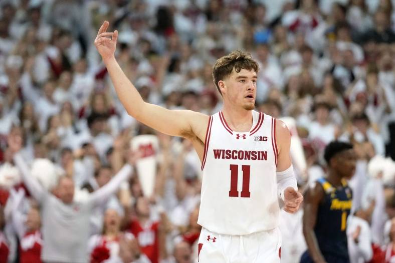 Dec 2, 2023; Madison, Wisconsin, USA;  Wisconsin Badgers guard Max Klesmit (11) celebrates after scoring a three point basket against the Marquette Golden Eagles during the first half at the Kohl Center. Mandatory Credit: Kayla Wolf-USA TODAY Sports