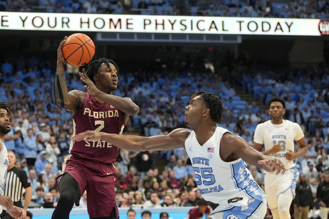 Dec 2, 2023; Chapel Hill, North Carolina, USA;  Florida State Seminoles forward Jamir Watkins (2) with the ball as North Carolina Tar Heels forward Harrison Ingram (55) defends in the first half at Dean E. Smith Center. Mandatory Credit: Bob Donnan-USA TODAY Sports