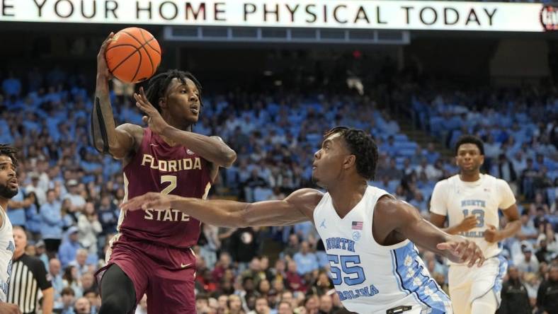 Dec 2, 2023; Chapel Hill, North Carolina, USA;  Florida State Seminoles forward Jamir Watkins (2) with the ball as North Carolina Tar Heels forward Harrison Ingram (55) defends in the first half at Dean E. Smith Center. Mandatory Credit: Bob Donnan-USA TODAY Sports