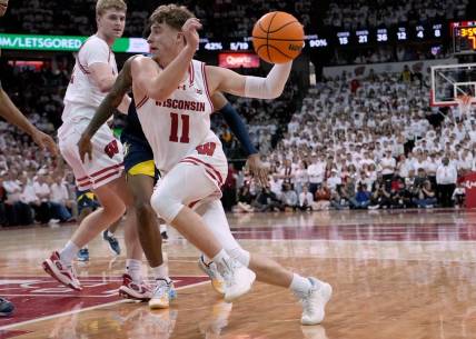 Dec 2, 2023; Madison, Wisconsin, USA; Wisconsin Badgers guard Max Klesmit (11) drives to the basket against the against Marquette Golden Eagles during the second half at the Kohl Center. Wisconsin won 75-64. Mandatory Credit: Mark Hoffman/Milwaukee Journal Sentinel via USA TODAY NETWORK