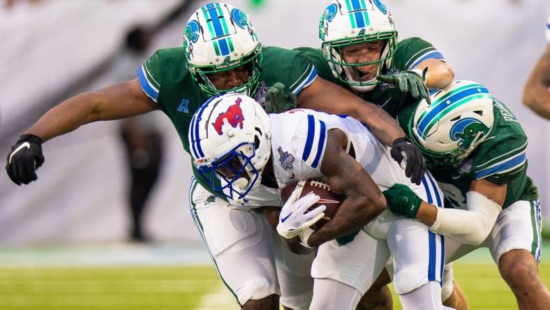 Dec 2, 2023; New Orleans, LA, USA; Southern Methodist Mustangs running back LJ Johnson Jr. (11) is tackled by Tulane Green Wave safety Kam Pedescleaux (8) during the first half at Yulman Stadium. Mandatory Credit: Stephen Lew-USA TODAY Sports