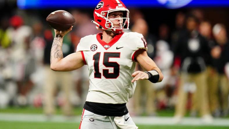 Dec 2, 2023; Atlanta, GA, USA;  Georgia Bulldogs quarterback Carson Beck (15) throws a pass against the Alabama Crimson Tide in the third quarter of the SEC Championship at Mercedes-Benz Stadium. Mandatory Credit: John David Mercer-USA TODAY Sports