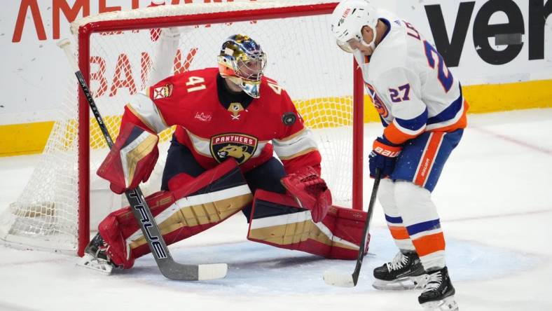 Dec 2, 2023; Sunrise, Florida, USA; Florida Panthers goaltender Anthony Stolarz (41) blocks the shot of New York Islanders left wing Anders Lee (27) during the second period at Amerant Bank Arena. Mandatory Credit: Jasen Vinlove-USA TODAY Sports