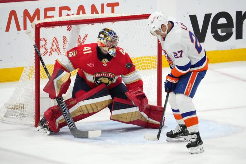 Dec 2, 2023; Sunrise, Florida, USA; Florida Panthers goaltender Anthony Stolarz (41) blocks the shot of New York Islanders left wing Anders Lee (27) during the second period at Amerant Bank Arena. Mandatory Credit: Jasen Vinlove-USA TODAY Sports