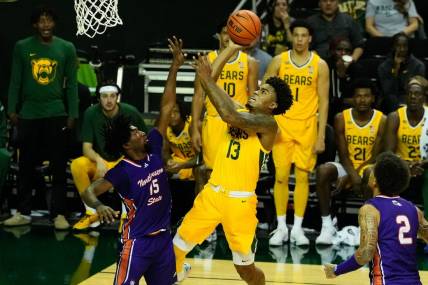 Dec 2, 2023; Waco, Texas, USA; Baylor Bears guard Langston Love (13) shoots against Northwestern State Demons guard Chase Forte (15) during the second half at Ferrell Center. Mandatory Credit: Chris Jones-USA TODAY Sports