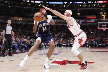 Dec 2, 2023; Chicago, Illinois, USA; New Orleans Pelicans forward Brandon Ingram (14) looks to shoot against Chicago Bulls guard Alex Caruso (6) during the first half at United Center. Mandatory Credit: Kamil Krzaczynski-USA TODAY Sports
