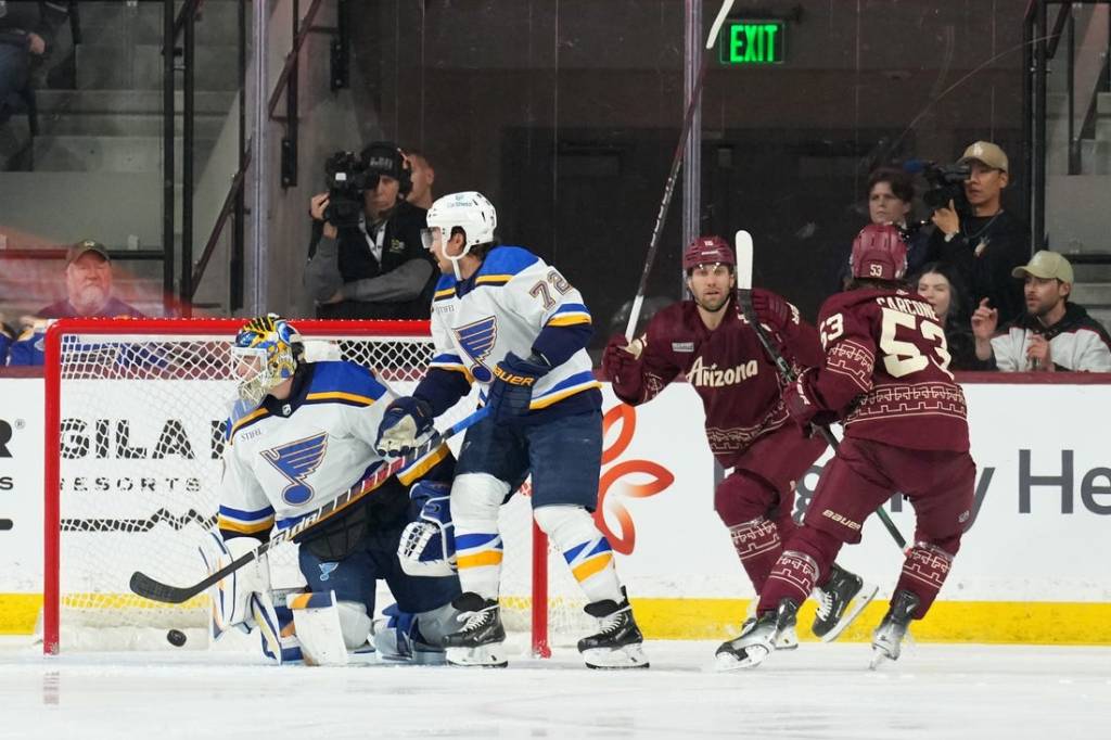 Dec 2, 2023; Tempe, Arizona, USA; Arizona Coyotes left wing Michael Carcone (53) scores against St. Louis Blues goaltender Joel Hofer (30) during the first period at Mullett Arena. Mandatory Credit: Joe Camporeale-USA TODAY Sports