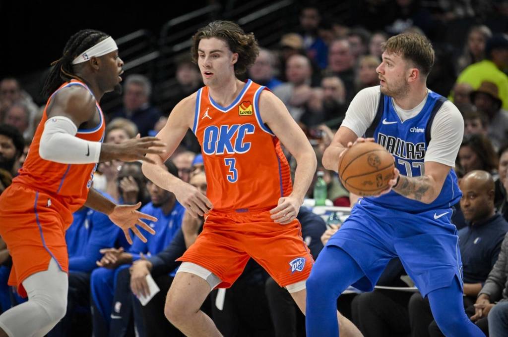 Dec 2, 2023; Dallas, Texas, USA; Dallas Mavericks guard Luka Doncic (77) looks to pass the ball past Oklahoma City Thunder guard Josh Giddey (3) during the second quarter at the American Airlines Center. Mandatory Credit: Jerome Miron-USA TODAY Sports