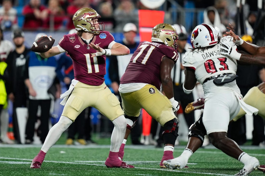 Dec 2, 2023; Charlotte, NC, USA; Florida State Seminoles quarterback Brock Glenn (11) throws against the Louisville Cardinals during the second quarter at Bank of America Stadium. Mandatory Credit: Jim Dedmon-USA TODAY Sports