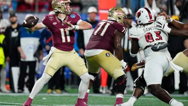 Dec 2, 2023; Charlotte, NC, USA; Florida State Seminoles quarterback Brock Glenn (11) throws against the Louisville Cardinals during the second quarter at Bank of America Stadium. Mandatory Credit: Jim Dedmon-USA TODAY Sports