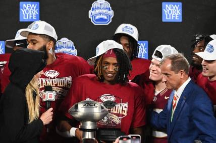 Dec 2, 2023; Charlotte, NC, USA; Florida State Seminoles running back Lawrance Toafili (9) is awarded the ACC Championship MVP trophy after the game against the Louisville Cardinals at Bank of America Stadium. Mandatory Credit: Bob Donnan-USA TODAY Sports