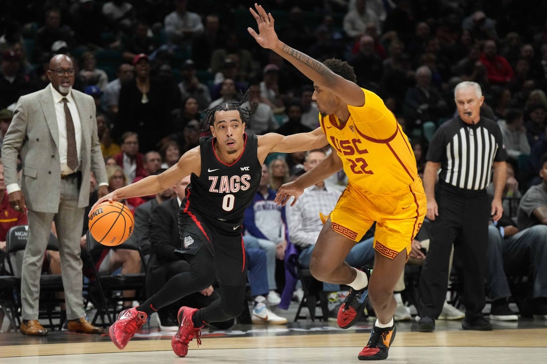 Dec 2, 2023; Las Vegas, Nevada, USA; Gonzaga Bulldogs guard Ryan Nembhard (0) dribbles against Southern California Trojans forward Arrinten Page (22) during the Legends of Basketball Las Vegas Invitational at MGM Grand Garden Arena. Mandatory Credit: Kirby Lee-USA TODAY Sports