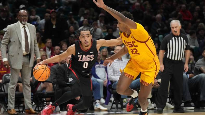 Dec 2, 2023; Las Vegas, Nevada, USA; Gonzaga Bulldogs guard Ryan Nembhard (0) dribbles against Southern California Trojans forward Arrinten Page (22) during the Legends of Basketball Las Vegas Invitational at MGM Grand Garden Arena. Mandatory Credit: Kirby Lee-USA TODAY Sports