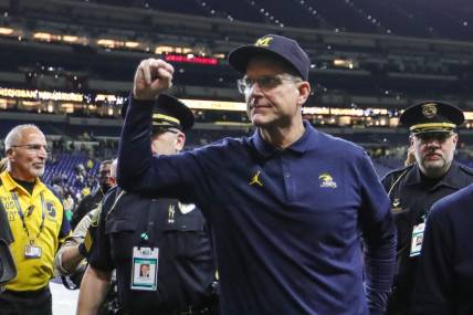 Michigan football coach Jim Harbaugh waves at fans after the Wolverines' 26-0 win over Iowa in the Big Ten championship game in Indianapolis on Dec. 2, 2023.