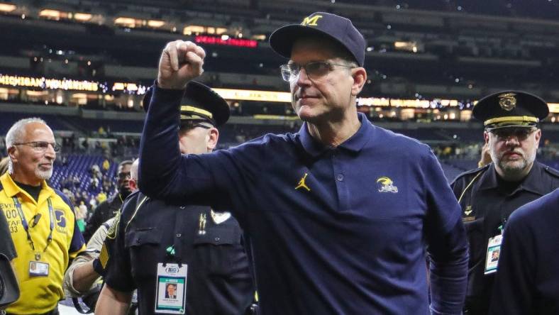 Michigan football coach Jim Harbaugh waves at fans after the Wolverines' 26-0 win over Iowa in the Big Ten championship game in Indianapolis on Dec. 2, 2023.