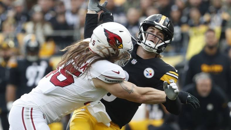 Dec 3, 2023; Pittsburgh, Pennsylvania, USA; Arizona Cardinals linebacker Dennis Gardeck (45) hits Pittsburgh Steelers quarterback Kenny Pickett (8) as he releases the football during the first quarter at Acrisure Stadium. Mandatory Credit: Charles LeClaire-USA TODAY Sports