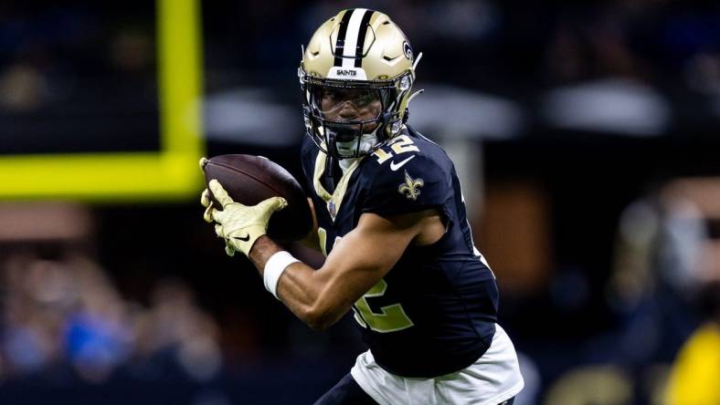 Dec 3, 2023; New Orleans, Louisiana, USA; New Orleans Saints wide receiver Chris Olave (12) catches a pass against the Detroit Lions during the first half at the Caesars Superdome. Mandatory Credit: Stephen Lew-USA TODAY Sports