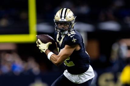 Dec 3, 2023; New Orleans, Louisiana, USA; New Orleans Saints wide receiver Chris Olave (12) catches a pass against the Detroit Lions during the first half at the Caesars Superdome. Mandatory Credit: Stephen Lew-USA TODAY Sports