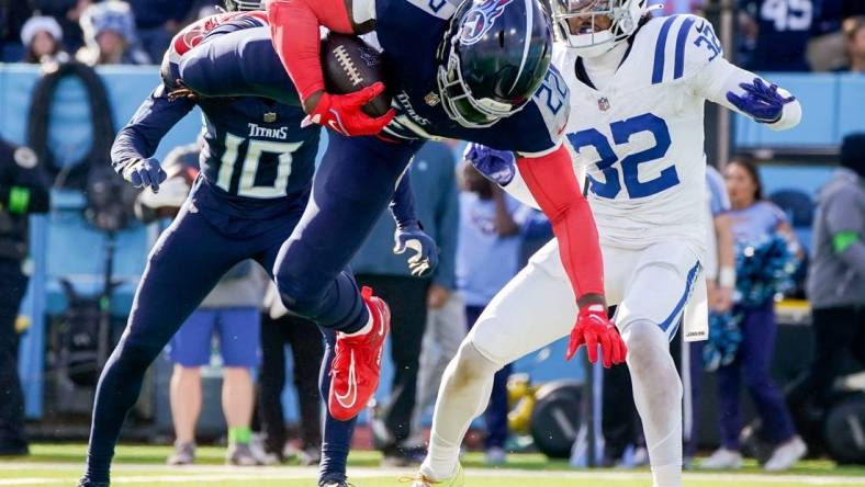 Tennessee Titans running back Derrick Henry (22) leaps for a touchdown against the Indianapolis Colts during the second quarter at Nissan Stadium in Nashville, Tenn., Sunday, Dec. 3, 2023.