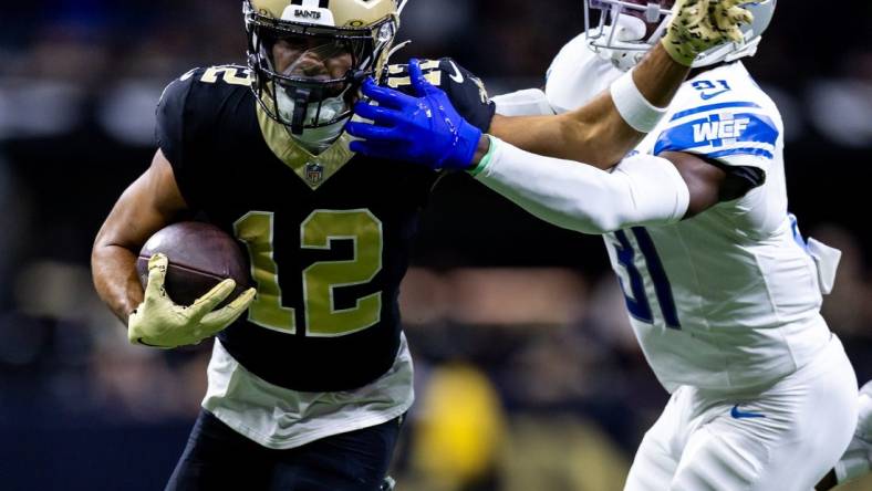 Dec 3, 2023; New Orleans, Louisiana, USA; Detroit Lions safety Kerby Joseph (31) tackles New Orleans Saints wide receiver Chris Olave (12) during the first half at the Caesars Superdome. Mandatory Credit: Stephen Lew-USA TODAY Sports