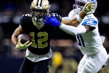 Dec 3, 2023; New Orleans, Louisiana, USA; Detroit Lions safety Kerby Joseph (31) tackles New Orleans Saints wide receiver Chris Olave (12) during the first half at the Caesars Superdome. Mandatory Credit: Stephen Lew-USA TODAY Sports