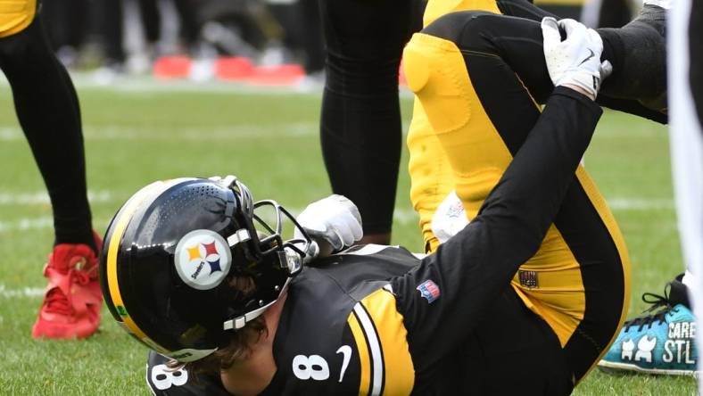 Dec 3, 2023; Pittsburgh, Pennsylvania, USA; Pittsburgh Steelers quarterback Kenny Pickett (8) grabs his leg after play against the Arizona Cardinals during the second quarter at Acrisure Stadium. Pickett left the game with an injury. Mandatory Credit: Philip G. Pavely-USA TODAY Sports