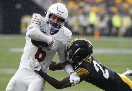 Dec 3, 2023; Pittsburgh, Pennsylvania, USA;  Arizona Cardinals running back James Conner (6) carries the ball against Pittsburgh Steelers cornerback Joey Porter Jr. (24) during the third quarter at Acrisure Stadium. Mandatory Credit: Charles LeClaire-USA TODAY Sports