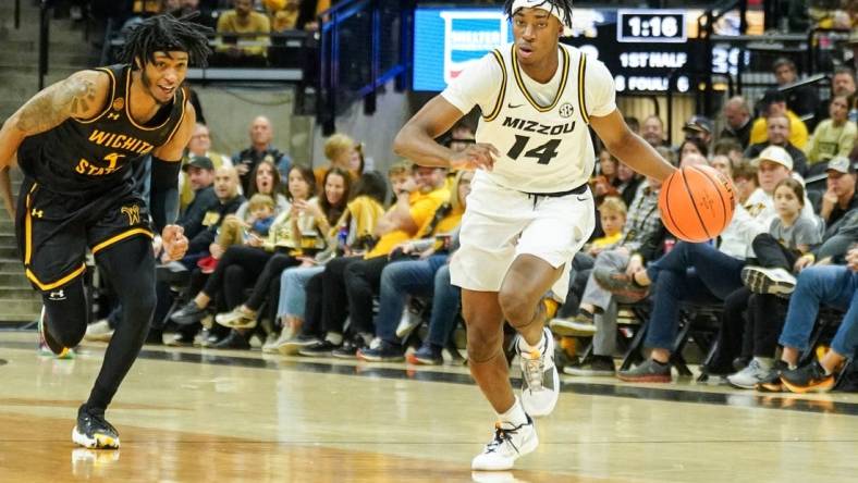 Dec 3, 2023; Columbia, Missouri, USA; Missouri Tigers guard Anthony Robinson II (14) steals the ball and dribbles as Wichita State Shockers guard Colby Rogers (4) defends during the first half at Mizzou Arena. Mandatory Credit: Denny Medley-USA TODAY Sports