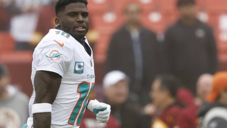 Dec 3, 2023; Landover, Maryland, USA; Miami Dolphins wide receiver Tyreek Hill (10) stands on the field during warm up prior to the game against the Washington Commanders at FedExField. Mandatory Credit: Geoff Burke-USA TODAY Sports