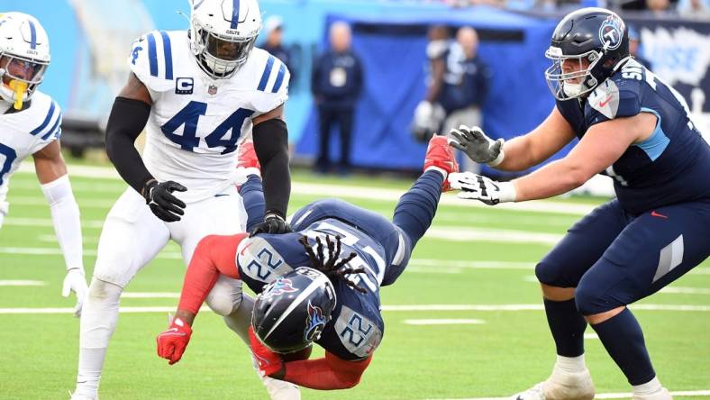 Dec 3, 2023; Nashville, Tennessee, USA; Tennessee Titans running back Derrick Henry (22) is tackled by Indianapolis Colts linebacker Zaire Franklin (44) during the second half at Nissan Stadium. Mandatory Credit: Christopher Hanewinckel-USA TODAY Sports