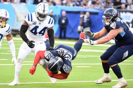 Dec 3, 2023; Nashville, Tennessee, USA; Tennessee Titans running back Derrick Henry (22) is tackled by Indianapolis Colts linebacker Zaire Franklin (44) during the second half at Nissan Stadium. Mandatory Credit: Christopher Hanewinckel-USA TODAY Sports