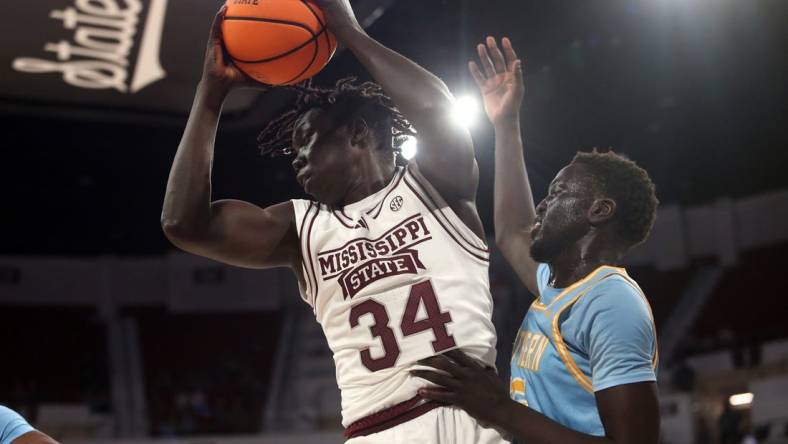 Dec 3, 2023; Starkville, Mississippi, USA; Mississippi State Bulldogs center Gai Chol (34) collects a rebound over Southern Jaguars forward Delang Muon (35) during the first half at Humphrey Coliseum. Mandatory Credit: Petre Thomas-USA TODAY Sports