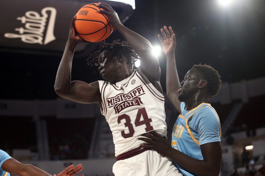 Dec 3, 2023; Starkville, Mississippi, USA; Mississippi State Bulldogs center Gai Chol (34) collects a rebound over Southern Jaguars forward Delang Muon (35) during the first half at Humphrey Coliseum. Mandatory Credit: Petre Thomas-USA TODAY Sports