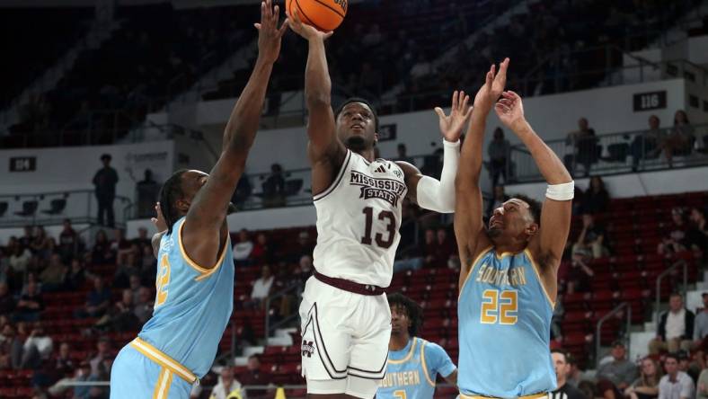 Dec 3, 2023; Starkville, Mississippi, USA; Mississippi State Bulldogs guard Josh Hubbard (13) shoots against Southern Jaguars forward Jalen Reynolds (12) and Southern Jaguars guard Tidjiane Dioumassi (22) during the first half at Humphrey Coliseum. Mandatory Credit: Petre Thomas-USA TODAY Sports