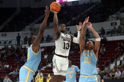 Dec 3, 2023; Starkville, Mississippi, USA; Mississippi State Bulldogs guard Josh Hubbard (13) shoots against Southern Jaguars forward Jalen Reynolds (12) and Southern Jaguars guard Tidjiane Dioumassi (22) during the first half at Humphrey Coliseum. Mandatory Credit: Petre Thomas-USA TODAY Sports