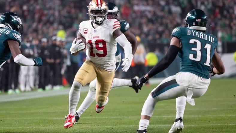 Dec 3, 2023; Philadelphia, Pennsylvania, USA; San Francisco 49ers wide receiver Deebo Samuel (19) runs with the ball against Philadelphia Eagles safety Kevin Byard (31) after a catch during the second quarter at Lincoln Financial Field. Mandatory Credit: Bill Streicher-USA TODAY Sports