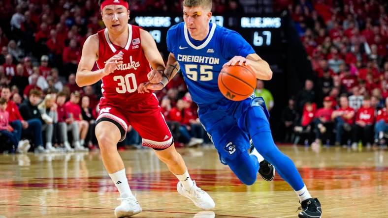 Dec 3, 2023; Lincoln, Nebraska, USA; Creighton Bluejays guard Baylor Scheierman (55) drives against Nebraska Cornhuskers guard Keisei Tominaga (30) during the second half at Pinnacle Bank Arena. Mandatory Credit: Dylan Widger-USA TODAY Sports