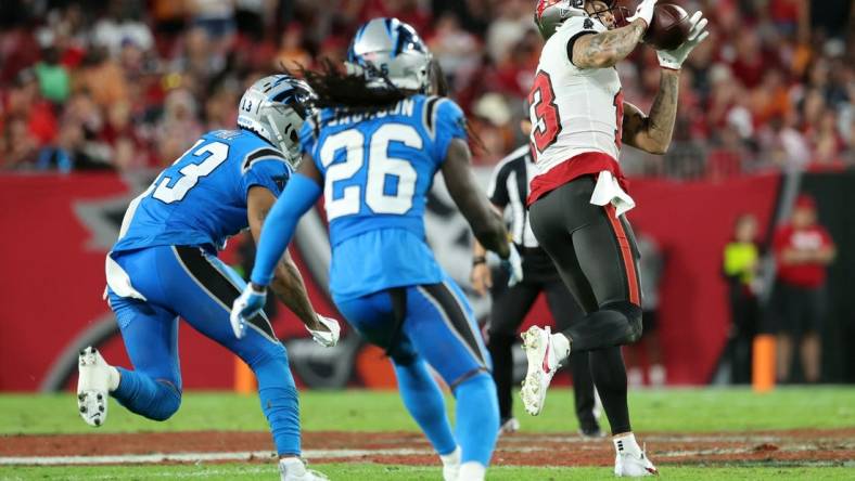 Dec 3, 2023; Tampa, Florida, USA; Tampa Bay Buccaneers wide receiver Mike Evans (13) catches the ball and runs it in for a touchdown  against the Carolina Panthers during the second half at Raymond James Stadium. Mandatory Credit: Kim Klement Neitzel-USA TODAY Sports