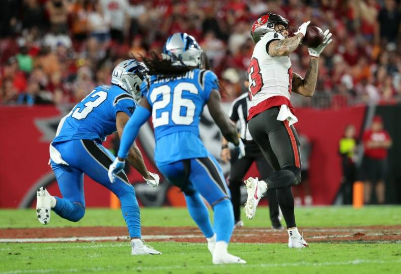 Dec 3, 2023; Tampa, Florida, USA; Tampa Bay Buccaneers wide receiver Mike Evans (13) catches the ball and runs it in for a touchdown  against the Carolina Panthers during the second half at Raymond James Stadium. Mandatory Credit: Kim Klement Neitzel-USA TODAY Sports