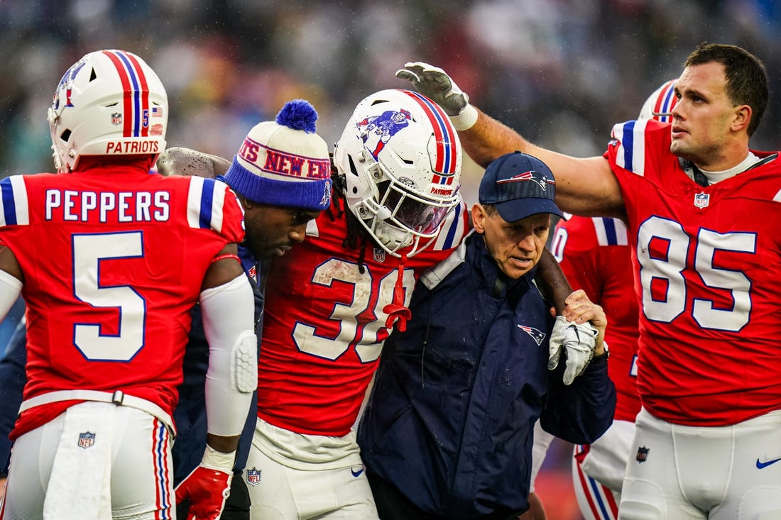 Dec 3, 2023; Foxborough, Massachusetts, USA; New England Patriots running back Rhamondre Stevenson (38) is helped off the field as they take on the Los Angeles Chargers in the second quarter at Gillette Stadium. Mandatory Credit: David Butler II-USA TODAY Sports