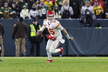 Dec 3, 2023; Green Bay, Wisconsin, USA;  Kansas City Chiefs quarterback Patrick Mahomes (15) scrambles with the football during the fourth quarter against the Green Bay Packers at Lambeau Field. Mandatory Credit: Jeff Hanisch-USA TODAY Sports