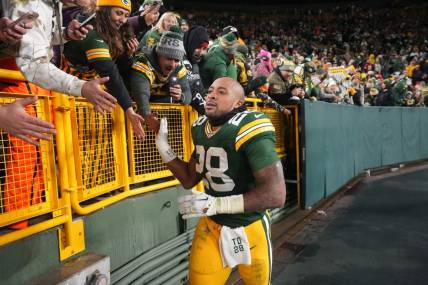 Dec 3, 2023; Green Bay, Wisconsin, USA; Green Bay Packers running back AJ Dillon (28) makes a victory lap after their game against the Kansas City Chiefs at Lambeau Field. Mandatory Credit: Mark Hoffman-USA TODAY Sports