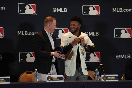 Dec 4, 2023; Nashville, TN, USA; Milwaukee Brewers general manager Matt Arnold presents Jackson Chourio with a team uniform and hat during the MLB 2023 Winter Meetings. Mandatory Credit: Kyle Schwab-USA TODAY Sports