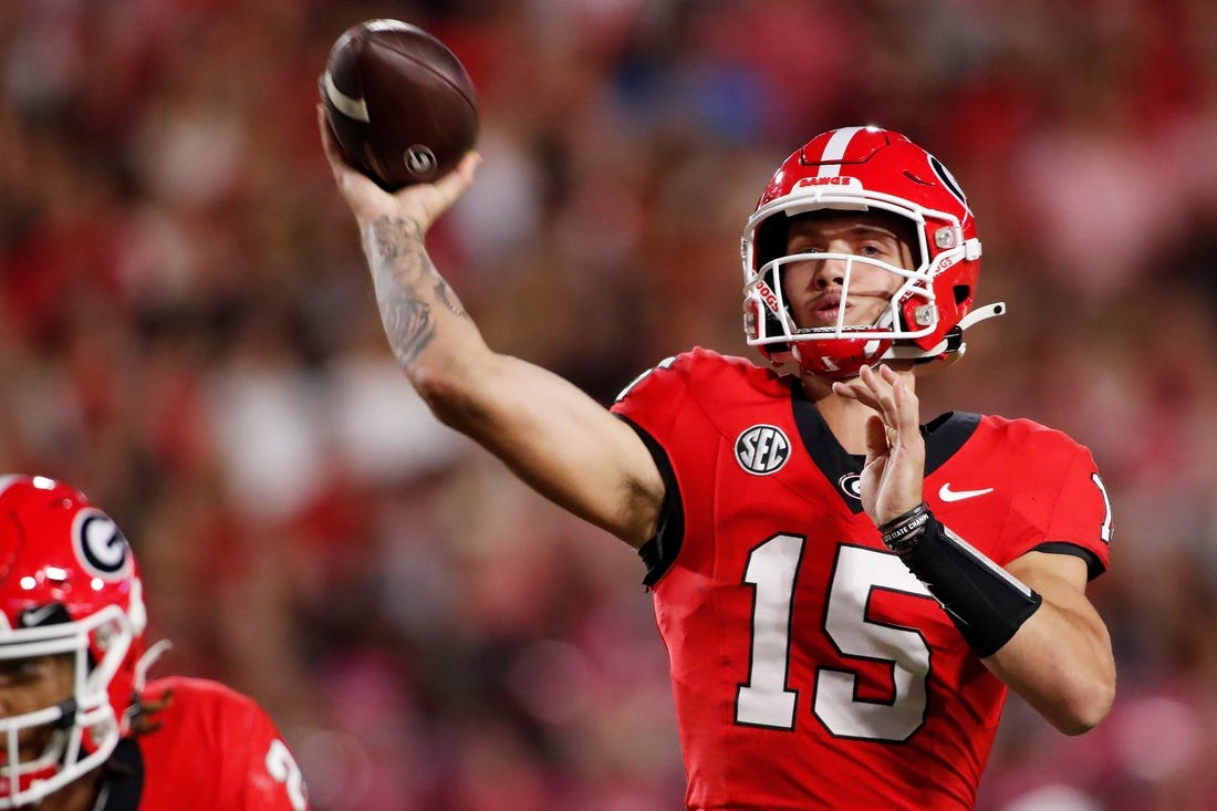 Georgia quarterback Carson Beck (15) throws a touchdown pass to Georgia wide receiver Rara Thomas (5) during the first half of a NCAA college football game against Kentucky in Athens, Ga., on Saturday, Oct. 7, 2023.