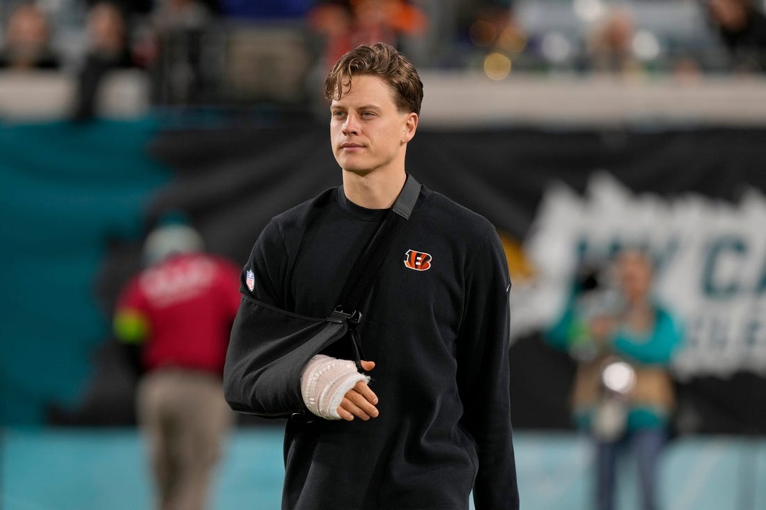 Cincinnati Bengals quarterback Joe Burrow takes the field to watch his team practice before facing the Jacksonville Jaguars at Everbank Stadium in Jacksonville, Florida Monday, December 4, 2023.