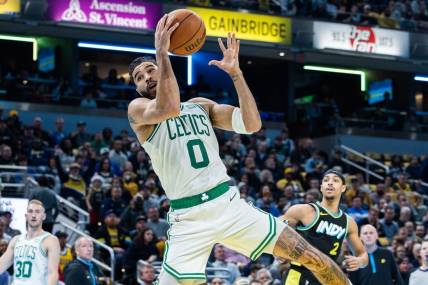 Dec 4, 2023; Indianapolis, Indiana, USA; Boston Celtics forward Jayson Tatum (0) rebounds the ball in the first half against the Indiana Pacers at Gainbridge Fieldhouse. Mandatory Credit: Trevor Ruszkowski-USA TODAY Sports