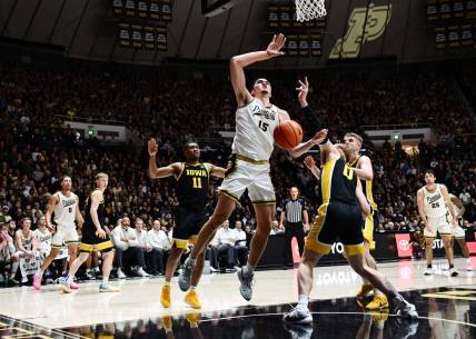 Dec 4, 2023; West Lafayette, Indiana, USA; Iowa Hawkeyes center Even Brauns (0) knocks the ball away from Purdue Boilermakers center Zach Edey (15) during the second half at Mackey Arena. Mandatory Credit: Marc Lebryk-USA TODAY Sports