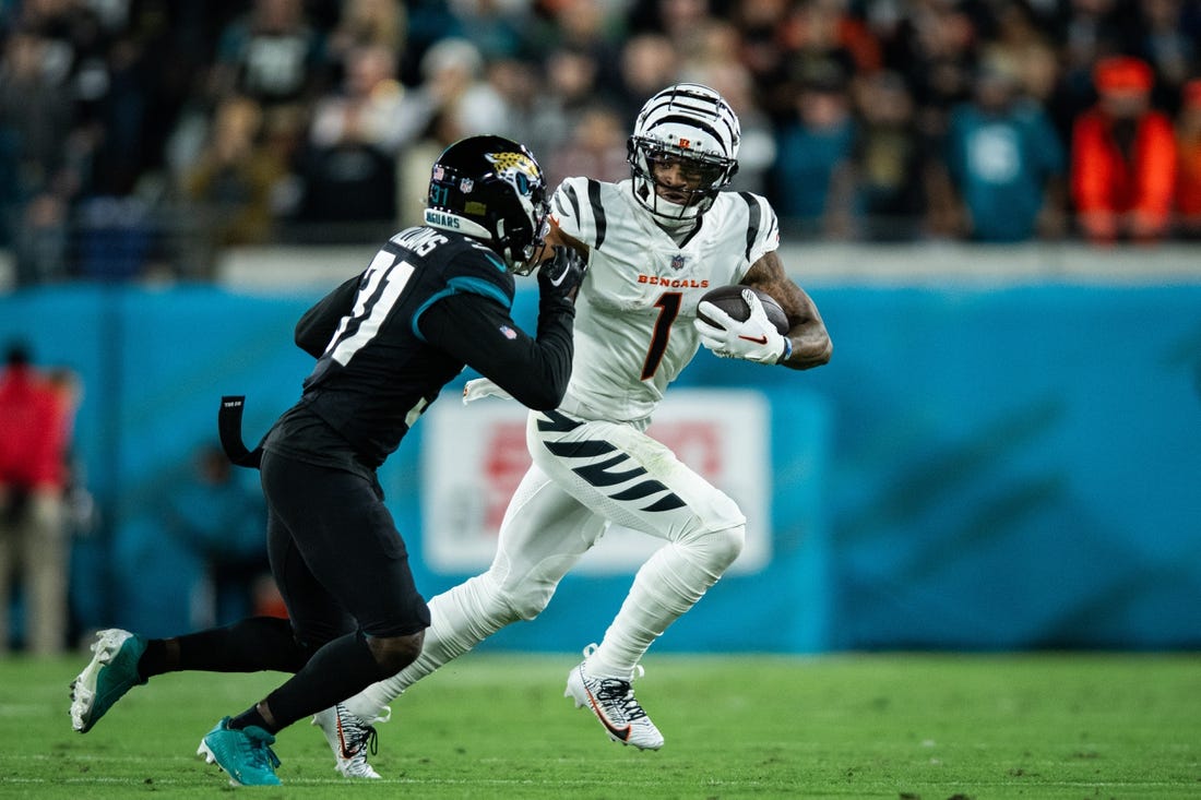Dec 4, 2023; Jacksonville, Florida, USA; Cincinnati Bengals wide receiver Ja'Marr Chase (1) runs with the ball after the catch against Jacksonville Jaguars cornerback Darious Williams (31) in the first quarter at EverBank Stadium. Mandatory Credit: Jeremy Reper-USA TODAY Sports