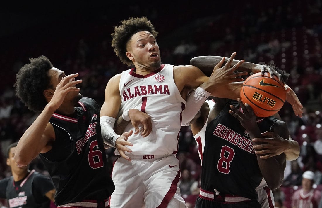 Dec 4, 2023; Tuscaloosa, Alabama, USA;  Arkansas State guard Taryn Todd (6), Alabama guard Mark Sears (1) and Arkansas State forward Lado Laku (8) fight to control a rebound at Coleman Coliseum. Mandatory Credit: Gary Cosby Jr.-USA TODAY Sports